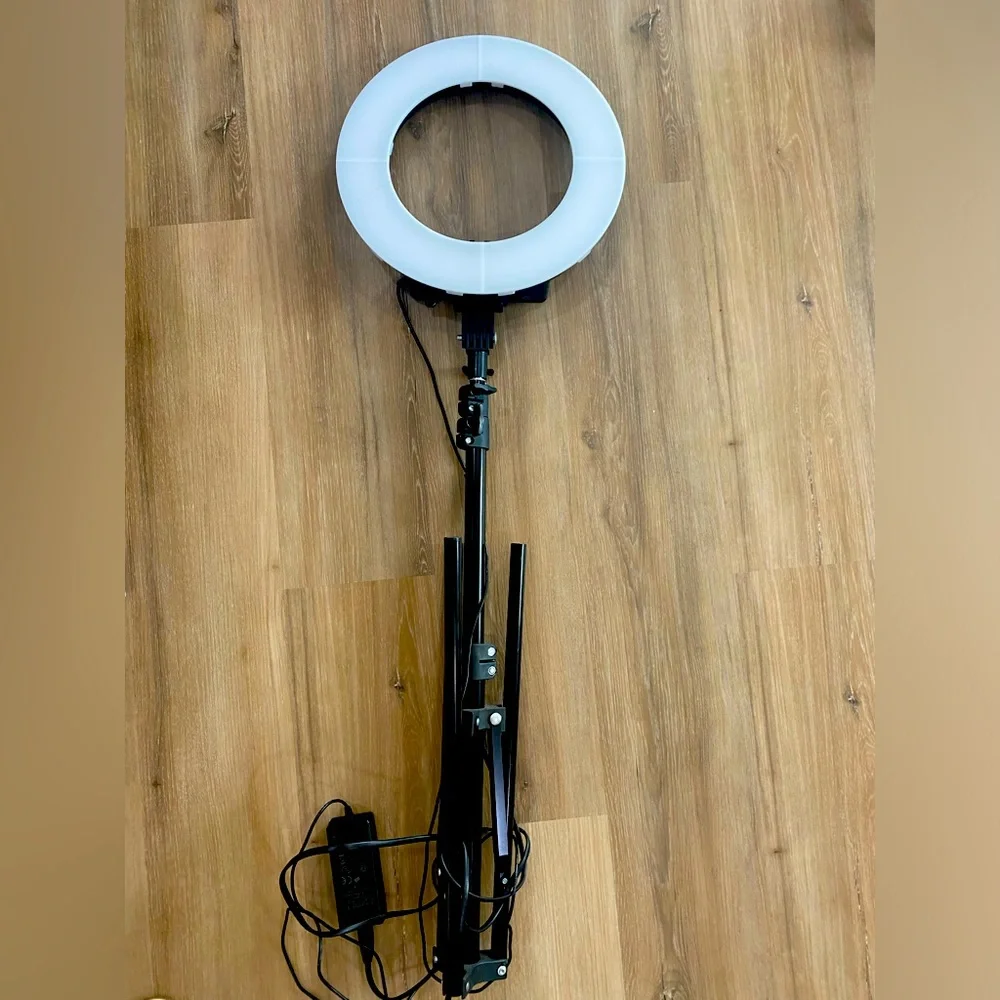 Ring light tripod with camera and phone attachment.